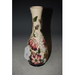 A MODERN MOORCROFT POTTERY BOTTLE VASE DECORATED WITH FLOWERS, FRUIT AND FOLIAGE