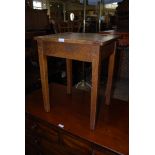 A CHILDS OAK SCHOOL DESK WITH HINGED TOP