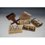 A VINTAGE STEREOSCOPE VIEWER AND ASSORTED PHOTOGRAPHIC CARDS.