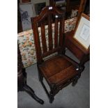 AN ANTIQUE OAK SIDE CHAIR WITH SOLID PLANK SEAT ON TURNED BLOCK SUPPORTS