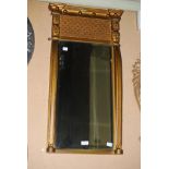 A REGENCY STYLE RECTANGULAR BEVELLED GILT WOOD WALL MIRROR WITH BALL SET FRIEZE AND MONOPODIA