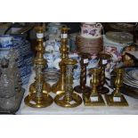FOUR PAIRS OF ASSORTED BRASS CANDLESTICKS.