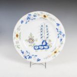 AN 18TH CENTURY DELFT CHARGER, DECORATED WITH GARDEN OF PEONY IN THE FAZACKERLY PALETTE, 35CM