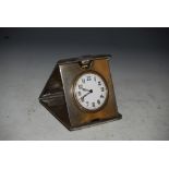 CHESTER SILVER CASED ART DECO STYLE TRAVELLING BEDSIDE CLOCK WITH WHITE ENAMEL DIAL BEARING ARABIC