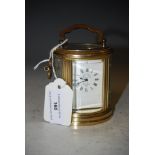 A FRENCH MINIATURE OVAL CARRIAGE CLOCK WITH WHITE ROMAN NUMERAL DIAL, L'EPEE, FRANCE