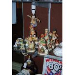 COLLECTION OF M. J. HUMMEL FIGURINES TO INCLUDE TABLE LAMP IN THE FORM OF APPLE TREE WITH BOY AND