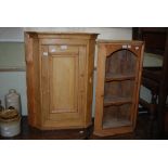 A PINE CORNER CUPBOARD WITH PANEL DOOR AND A SMALL PINE CORNER CUPBOARD WITH THREE OPEN SHELVES