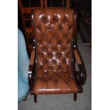 A BUTTON DOWN LEATHERETTE UPHOLSTERED MAHOGANY ARM CHAIR WITH BRASS STUDDED DETAIL