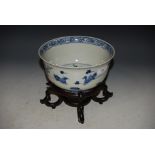 A CHINESE PORCELAIN BLUE AND WHITE BOWL, THE INTERIOR DECORATED WITH LOTUS AND DUCKS ON CARVED