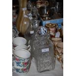 PAIR OF CLEAR CUT GLASS DECANTERS AND STOPPERS, TOGETHER WITH ANOTHER SQUARE SHAPED DECANTER AND