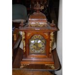 A WALNUT AND GILT METAL MOUNTED BRACKET CLOCK OF ARCHITECTURAL FORM WITH TWIN-TRAIN MOVEMENT