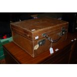 A LEATHER CASE CONTAINING ASSORTED COPPER AND BRASSWARE, FRYING PANS, SAUCE PANS, KETTLE, BELLS,