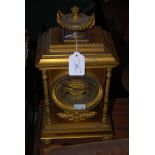 LATE 19TH CENTURY GILT METAL MANTEL CLOCK, WITH URN SHAPED SURMOUNT, SILVER DIAL WITH ARABIC