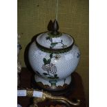 A CHINESE WHITE GROUND CLOISONNE JAR AND COVER ON HARDWOOD STAND