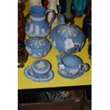 A WEDGWOOD JASPERWARE TEA SET, TOGETHER WITH A JUG AND TWO PIN DISHES, ALL IN PALE BLUE