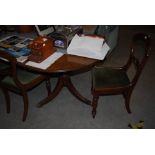 AN EARLY 20TH CENTURY MAHOGANY EXTENDING D-END DINING TABLE, BOTH ENDS SUPPORTED BY TWO TRI-POD