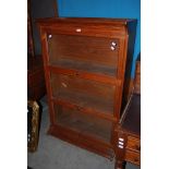 AN EARLY 20TH CENTURY TEAK GLAZED DISPLAY CABINET WITH THREE SHELVES WITH GLAZED SWING FOLD-AWAY