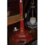 AN ART DECO CHINOISSERIE RED LACQUER STANDARD LAMP ON OCTAGONAL PLINTH
