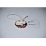 AN 18CT GOLD RUBY AND DIAMOND NINE STONE RING