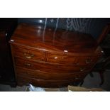 AN EARLY 20TH CENTURY MAHOGANY AND SATINWOOD BANDED BOWFRONT CHEST OF THREE SHORT OVER THREE LONG
