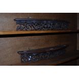 A PAIR OF BOWFRONT HANGING SHELVES WITH PIERCED AND FOLIATE CARVED FRIEZE DETAIL