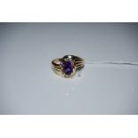 A YELLOW METAL AMETHYST AND DIAMOND SET COCKTAIL RING