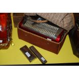 A HOHNER ACCORDIAN INSIDE A CANVAS BAG TOGETHER WITH TWO MOUTH ORGANS/HARMONICAS BOTH BY ECHO