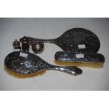 A BIRMINGHAM SILVER THREE PIECE DRESSING TABLE SET COMPRISING HAND-HELD MIRROR AND TWO BRUSHES,
