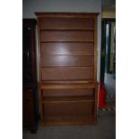 A REPRODUCTION OAK REGENCY STYLE OPEN BOOKCASE