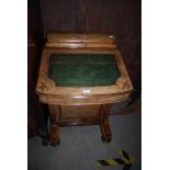 A LATE 19TH CENTURY WALNUT DAVENPORT, THE DESK WITH TOP STATIONARY COMPARTMENT, THE INTERIOR OF