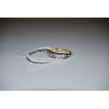 A 9CT GOLD AND CUBIC ZIRCONIA SEVEN STONE RING