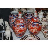 A PAIR OF LATE 19TH/ EARLY 20TH CENTURY IMARI JARS TOGETHER WITH A SIMILAR PAIR OF IMARI JARS AND