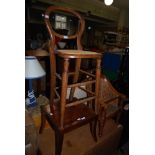 TWO EARLY 20TH CENTURY CHILDRENS CHAIRS INCLUDING A BALLOON BACKED HIGH CHAIR WITH CANED SEAT AND