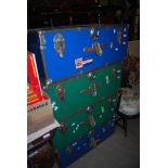 FOUR 20TH CENTURY TRAVEL TRUNKS OF PLASTIC PANELS WITH METAL EDGING, TWO BLUE AND TWO IN GREEN, SOME