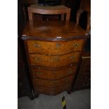 A REPRODUCTION WALNUT TALL SERPENTINE CHEST OF TWO DRAWERS OVER BRUSH SLIDE AND THREE FURTHER