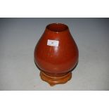 A CHINESE ORANGE GROUND PORCELAIN VASE WITH SPECKLED GROUND ON HARDWOOD STAND, INCISED MARKS.