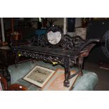 A CHINESE DARKWOOD DAY BED, LATE 19TH / EARLY 20TH CENTURY, THE SCROLL CARVED BACK CENTRED WITH A