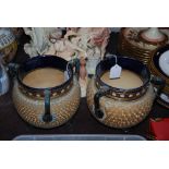 PAIR OF EDWARDIAN ROYAL DOULTON STONEWARE VASES IN THE FORMS OF TRIPOD URNS