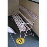 A WHITE PAINTED REGENCY STYLE WROUGHT IRON GARDEN BENCH WITH WOODEN SLATS