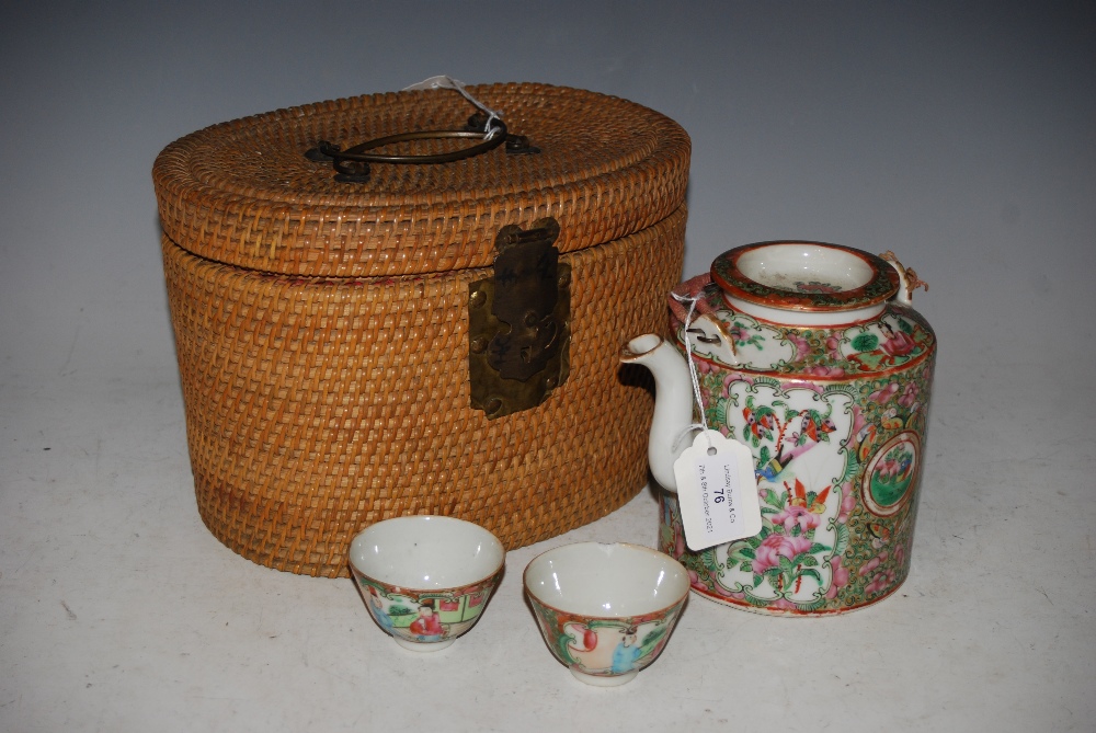 CHINESE PORCELAIN FAMILLE ROSE CANTON TEA KETTLE, COVER AND TWO TEA BOWLS IN ORIGINAL WICKER CASE.