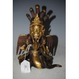 A BURMESE GILT BRONZED FIGURE OF A DEITY OFFERING A SHELL