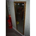 A GILT FRAMED RECTANGULAR BEVELLED WALL MIRROR