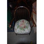 A MID 20TH CENTURY DARK STAINED ERCOL WINDSOR STYLE ARMCHAIR WITH UPHOLSTERED CUSHION