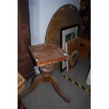 A 20TH CENTURY BEECH TILT TOP BREAKFAST TABLE ON A TRIPOD BASE WITH CATORS (DAMAGES)