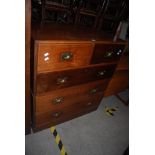 AN EARLY 20TH CENTURY TEAK CAMPAIGN CHEST OF DRAWERS, THE TOP SECTION WITH TWO SHORT DRAWERS OVER
