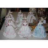 A GROUP OF TEN ROYAL WORCESTER LADY FIGURES, ALL IN VICTORIAN STYLE DRESSES