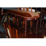 A VICTORIAN NEEDLEWORK AND VELVET UPHOLSTERED ROUNDED RECTANGULAR WINDOW STOOL ON FOUR TAPERED