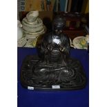 A MODERN ASIAN BRONZE EFFECT POTTERY FIGURE OF A SEATED BUDDHA