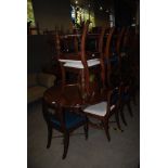 AN EARLY 20TH CENTURY MAHOGANY EXTENDING D-END DINING TABLE SUPPORTED ON TWO TRI-POD BASES WITH