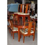 A CHINESE DARKWOOD EXTENDING DINING TABLE AND EIGHT CHAIRS COMPRISING TWO CARVERS AND SIX SIDE